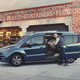 A photo of a blue Ford Transit Connect at a garden center.